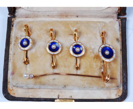 A cased set of four 15ct gold collar studs, each set with a seed pearl in blue and white enamel surrounds, and on safety pins
