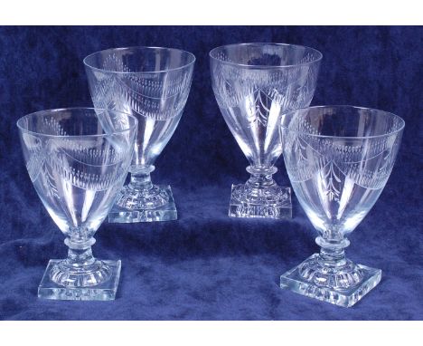 A set of four Regency glass goblets, the wheel engraved conical bowls on lemon squeezer square bases, h.15cm Condition Report
