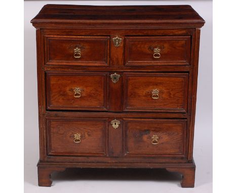 A Jacobean period joined oak chest, having a planked top above two short and two long graduated drawers, on bracket feet (wit