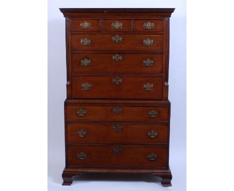 A George III oak chest-on-chest, the upper section having a dentil moulded cornice and quarter turned fluted pilasters, the b