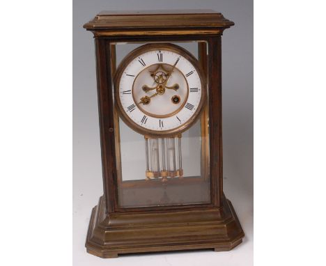 A late 19th century lacquered brass four glass mantel clock, having white enamel chapter ring with Roman numerals, visible es