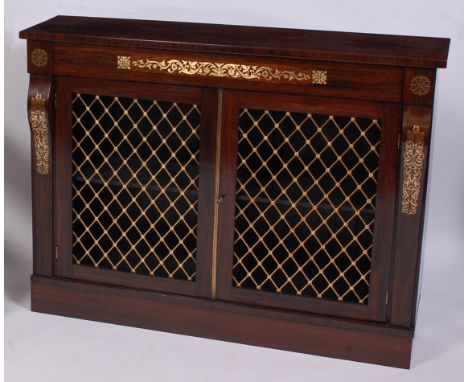 A Regency rosewood and brass inlaid side cabinet, having twin lattice brass grille doors enclosing shelved interior (restored