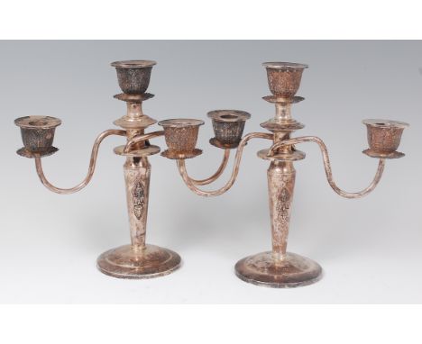 A pair of Thai sterling silver three light candelabra, each column adorned with a figure in respectful Anjali Mudra pose and 