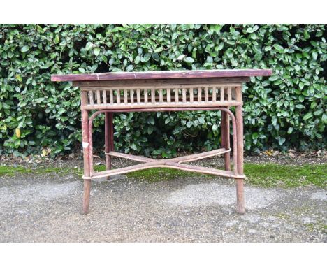 A vintage bamboo conservatory table with faux ceramic tiled top. H.68 W.96 D.66cm 