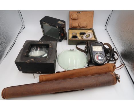 A selection of photography accessories including Lenses, tripods. light meter etc.