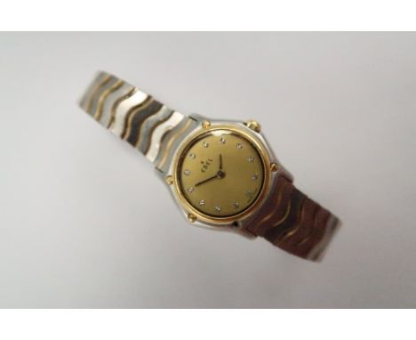 A lady's Ebel wristwatch, the signed dial with diamond set numerals, in slim two-tone case, numbered to the back 51609715 abo