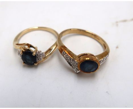 Two 9ct gold sapphire and diamond crossover rings. To include an oval sapphire with four diamonds to each side, Size K. An ov
