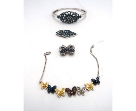 A group of silver and diamond jewellery. To include a hinged blue diamond cluster bangle, diameter 68mm stated diamond weight