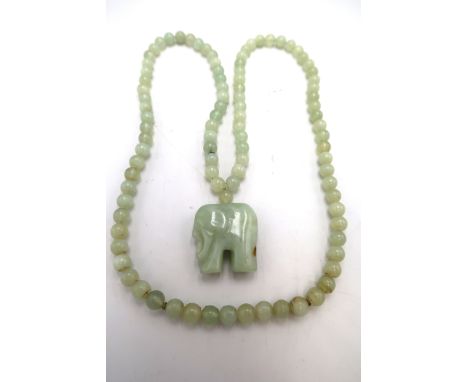 A jade elephant pendant on matching beaded necklace.