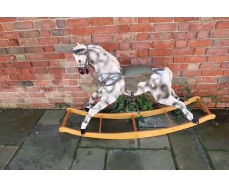 A vintage PC and R Schday Rocking Horse, dapple grey with green saddle and bridle, on bow rocker, 1.5m long by 1m high.