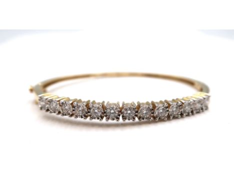 A 14ct yellow gold hinged bangle set with approx 1.3ct of diamonds, diamonds are a good colour, colour G, s1 clarity