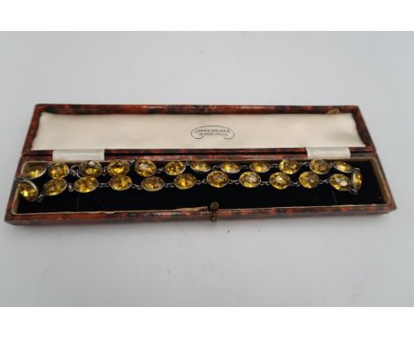A late 19th or early 20th century Continental 800 silver and light honey coloured paste riviere necklace, each of the twenty 
