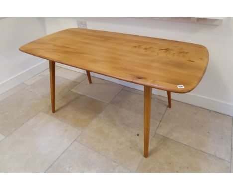 A blonde Ercol refectory table 150 by 77 by 71cm high, small split to the top, otherwise good condition.