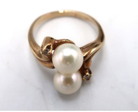 A 10ct gold, marked, white stone and pearl ring set with two pearls, size K, 3.1g.