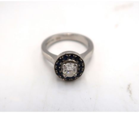 A Harriet Kelsall diamond and sapphire engagement ring, the central diamond of approximately 0.64ct, colour G, VSI, surrounde