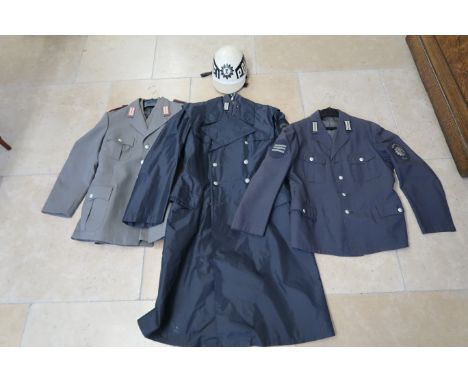 An East German Politzei uniform, two tunics, overcoat and helmet