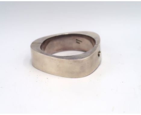 A Mexican silver geometric hinged bangle in the form of a triangle, marked Mexico 925, 83.35g.