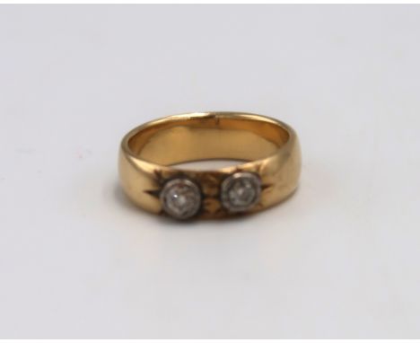 An 18ct and old cut diamond two stone ring, each diamond of approximately 0.125ct, unmarked, but testing as at least 18ct, si