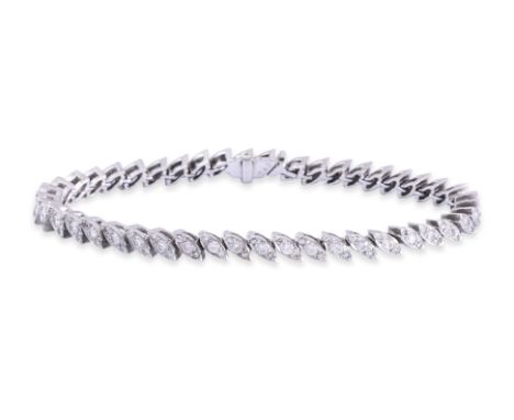 A DIAMOND 'TENNIS' BRACELET
Featuring round brilliant cut diamonds totalling approximately 1.35 Cts, mounted in an unmarked w