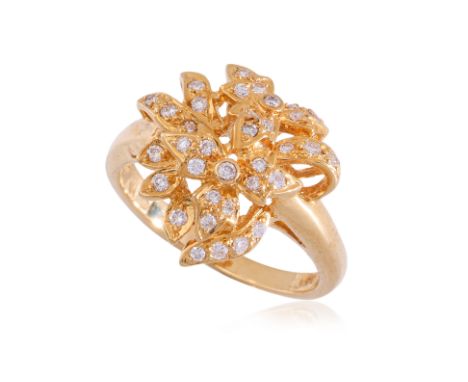 A HIGH KARAT GOLD DIAMOND 'FLOWER' RING
Featuring round cut diamonds totalling approximately 0.33 Cts, mounted in a high kara