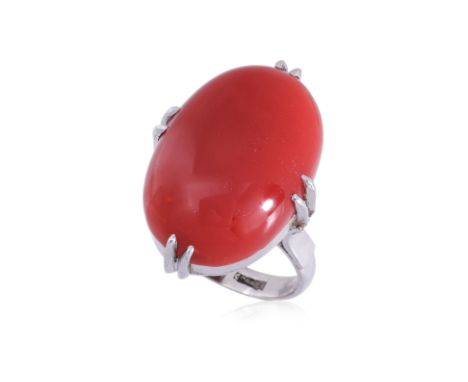 A RED CORAL RING
Featuring a red coral cabochon measuring approximately 20.7mm x 14.2mm, mounted in an unmarked white metal s