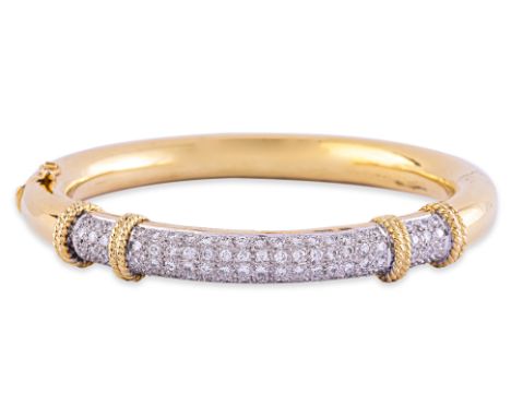 A DIAMOND HINGED BANGLE
Featuring round brilliant cut diamonds totalling approximately 0.88 Cts, mounted in a two tone gold s