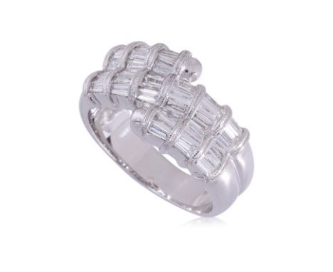 A TAPERED BAGUETTE DIAMOND RING
Featuring tapered baguette diamonds totalling approximately 1.10 Cts, mounted in a white gold