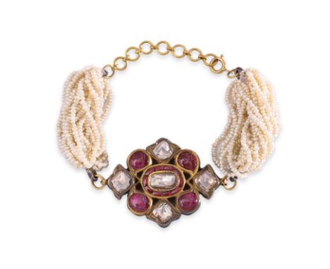 AN ANTIQUE INDIAN DIAMOND AND RUBY BRACELET Circa early 20th century, featuring five foiled backed diamond pieces, alongside 