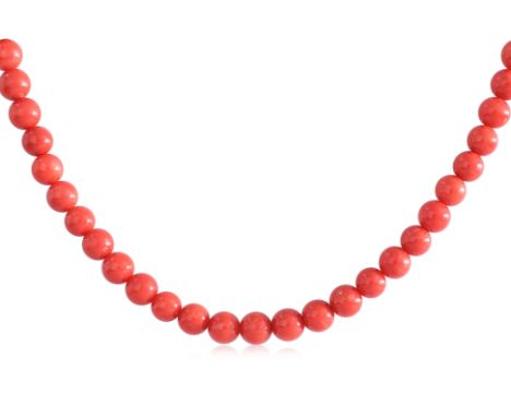 A RED CORAL BEAD NECKLACE
Featuring coral beads measuring approximately 6.50-7.00mm, attached to a gold plated silver 'flower