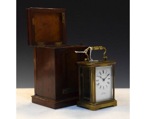 French brass cased carriage clock, the white enamel dial with Roman numerals, in a mahogany outer carrying case   Condition: 