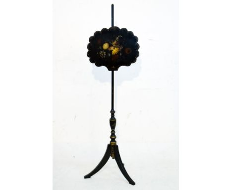 Victorian ebonised pole screen, the shaped oval panel with painted foliate decoration, standing on a gilt highlighted turned 