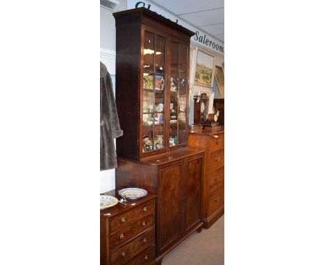 19th Century mahogany two section bookcase, the upper section fitted four shelves enclosed by a pair of glazed doors, the bas