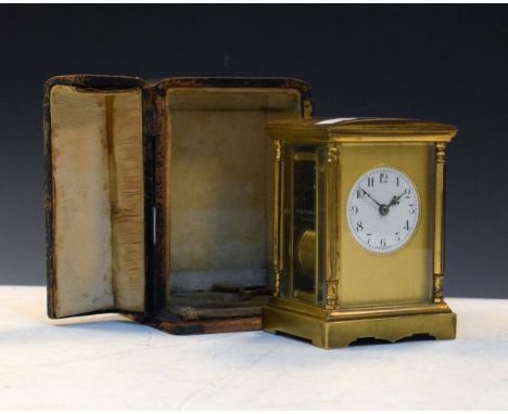 French brass cased carriage clock, the circular white enamel dial with Arabic numerals and set within a satin brass mask, bra