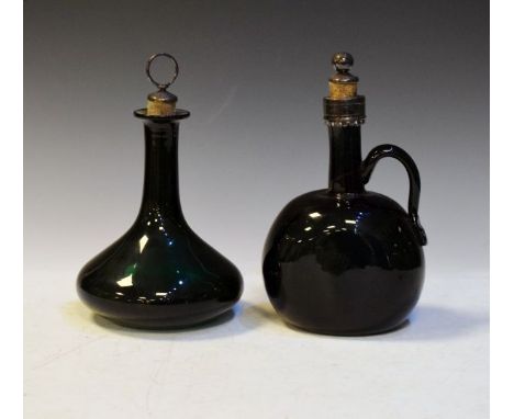 19th Century green glass baluster shaped decanter, together with a somewhat similar carafe, each having a white metal mounted