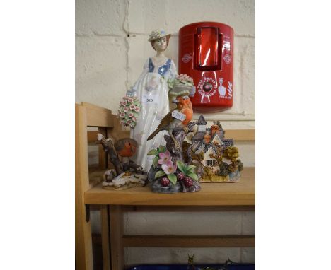 A Lilliput Lane model together with figure of a lady and two robin figurines