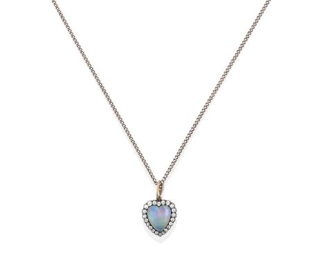 the heart shaped cabochon opal within a border of old cut diamonds, in white claw settings, suspended from a rose cut and old