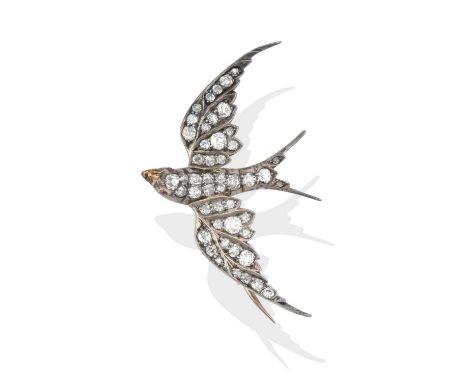 realistically modelled in flight, with round cabochon ruby eyes and a body set throughout with old cut diamonds, total estima