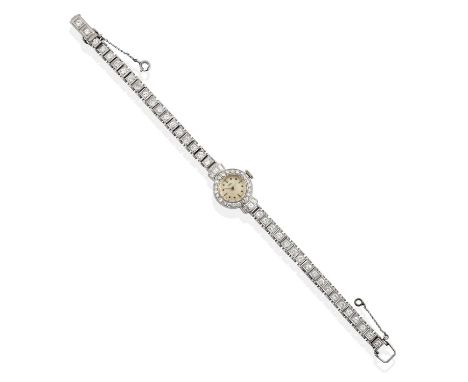the silvered dial with dot and baton markers, within an eight-cut diamond set bezel and baguette cut diamond set lugs, in whi