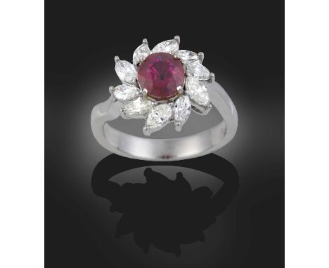 the oval cut ruby within a border marquise cut diamonds, in white claw settings, to a tapered shoulder plain polished shank, 