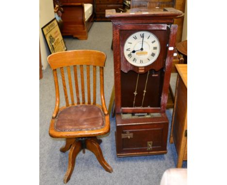 A time recording clock and a early 20th century swivel oak office chair 