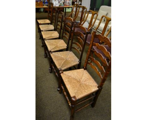 Six rush seated ladder back dining chairs 