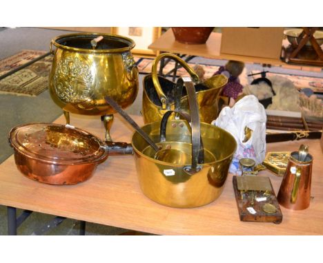 A collection of 19th/20th century copper and brasswares including coal helmet, trivets, bed warmer, postal scales, pans, kett