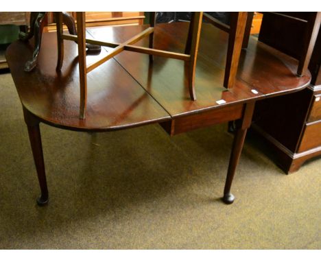 A 19th century mahogany gate leg dining table on pad feet