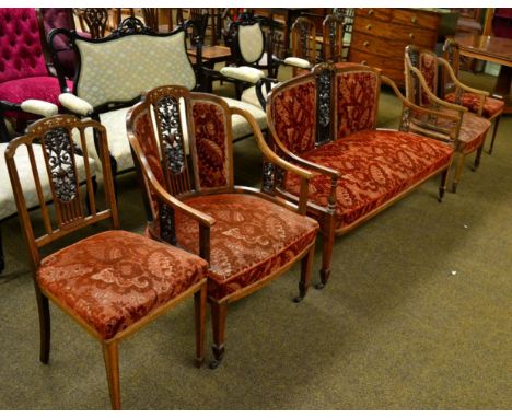 A seven piece Edwardian inlaid rosewood parlour suite comprising four occasional chairs, two elbow chairs and a sofa