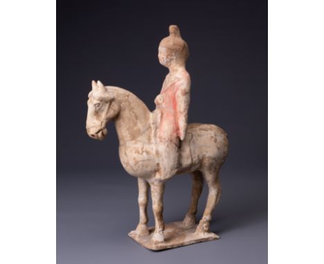 A CHINESE PAINTED POTTERY HORSE AND FEMALE RIDER, TANG DYNASTY (AD 618-907). The horse standing foursquare with the rider sea