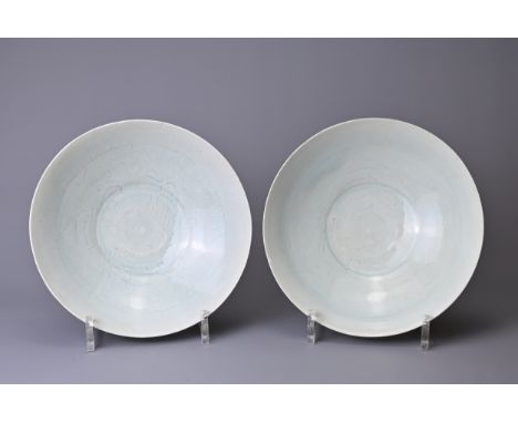 A CLOSE PAIR OF CHINESE QINGBAI WARE BOWLS, SONG DYNASTY (960-1279). Each with wide gently rounded sides on a tapered foot de