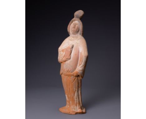 A CHINESE TANG DYNASTY (AD 618-907) PAINTED POTTERY FIGURE OF COURT LADY.  Modelled standing wearing a long flowing robe, wit