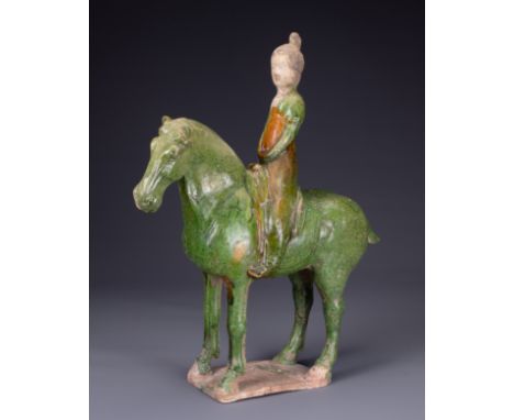 A CHINESE SANCAI GLAZED POTTERY MODEL OF A HORSE AND FEMALE RIDER, TL TESTED, TANG DYNASTY (AD 618-907). Modelled seated astr