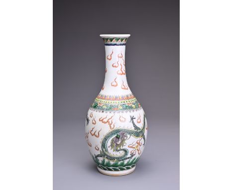 A CHINESE FAMILLE VERTE PORCELAIN VASE, 19TH CENTURY. Of bottle form decorated with two dragons chasing flaming pearls amongs