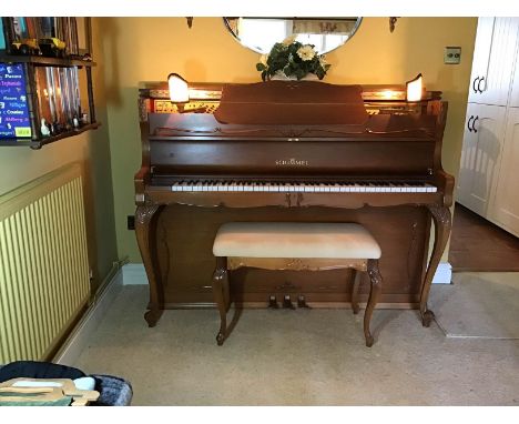 Schimmel (c1988) An upright piano in a walnut Chippendale style case with carved cabriole front legs and 2 folding electric l
